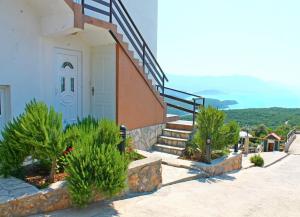 a building with stairs and a stair case with plants at Apartments Villa Milna 1 in Budva
