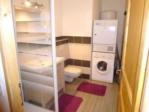 a small bathroom with a washing machine and a washer at La Gentiane in Le Mont-Dore