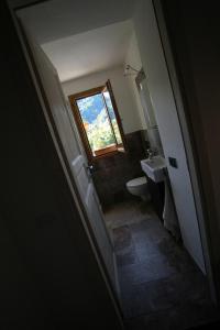 a bathroom with a sink and a window at Agriturismo Giumin in Rocchetta di Vara +12 photos