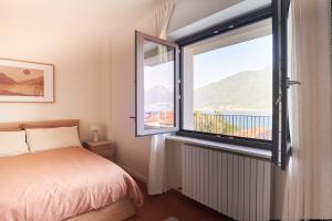 a bedroom with a bed and a large window at Casa Terracotta in Cremia