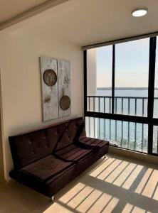 a bedroom with a bed and a large window at leslies apartamentos in Cartagena de Indias