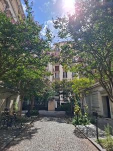 a cobblestone street in front of a building at Very nice private Appartment 1 living room with sofa bed 1 bedroom 1 bathroom with toilet 1 Kitchen in Paris