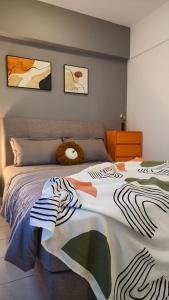 a bedroom with a bed with a teddy bear on it at Event Hubs - Axiata Arena, Stadium Bukit Jalil in Kuala Lumpur