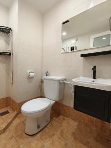 a bathroom with a white toilet and a sink at Event Hubs - Axiata Arena, Stadium Bukit Jalil in Kuala Lumpur +14 photos