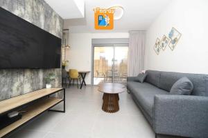 a living room with a couch and a table at סויטת דקל in Eilat