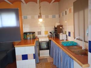 a kitchen with a sink and a counter top at Casa para fines de semana cuevas del turche buñol in Buñol +10 photos