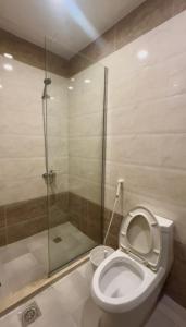 a bathroom with a toilet and a glass shower at Al Murjan Compound Villa in Jeddah +8 photos