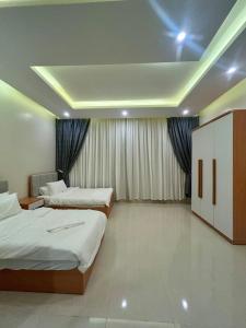 a hotel room with two beds and a ceiling at Al Murjan Compound Villa in Jeddah