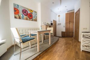 a living room with a dining room table and chairs at Ginger Apartment Riga in Riga