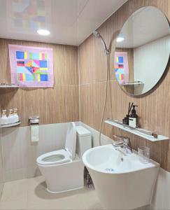 a bathroom with a toilet and a sink and a mirror at Slow accommodation,Free parking,kspo dome,Kangdong Sacred Heart Hospital,Seoul Asan Hospital,COEX,Lotte World Tower,kspo in Seoul