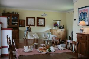a dining room with a table and a couch at B&B Santa Fosca in Pederobba
