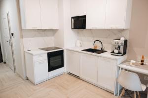 Kuchyň nebo kuchyňský kout v ubytování Rezydencja Ogród Saski Lublin