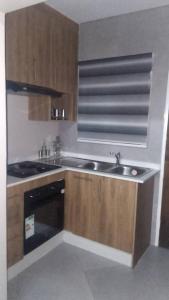 a kitchen with a sink and a stove at Kasane Boutique House in Kasane +2 photos