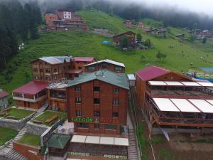 a group of buildings on top of a green hill at Gelgor Hotel in Ayder Yaylasi