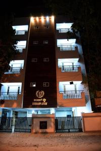 a large building with lights on the side of it at Urbanstay Service Appartment in Bengaluru