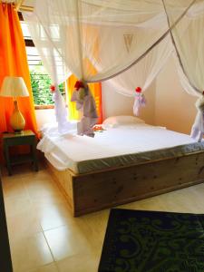 a bedroom with a bed with a canopy at Retro in Zanzibar City