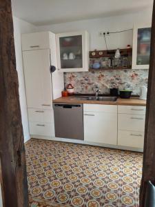 a kitchen with white cabinets and a sink at Ferienhaus Wesertal Monteur in Gottstreu