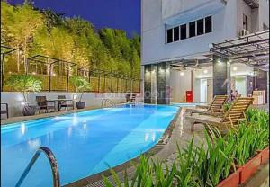 a large swimming pool with chairs and a building at Nagoya Mansion B1222 in Nagoya