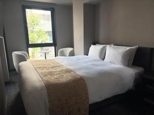 a hotel room with a large bed with a window at hotel bolam kyoto in Shimo-dachiyuuridōri +9 photos