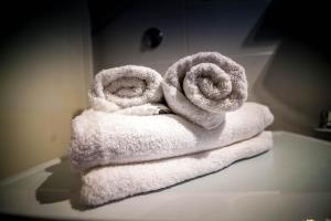 a pile of towels sitting on top of a table at Villa Arboretum in Milna +16 photos