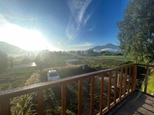 a view from the deck of a house with a chair at The Iris Vulcano's in Kubupenlokan