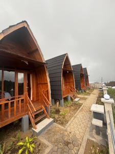 a row of wooden huts in a row at Pondok Kebun Sayur in Bedugul