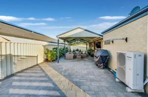 a house with a patio with a heater at Room in a house in Eaton +3 photos
