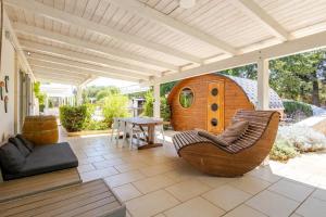 a patio with a chair and a dog house at Casa Relax - Bellavista Sauna & SPA by TrulloVista in Martina Franca