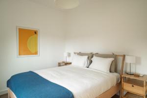 a bedroom with a white bed and two lamps at Bela Vista - Countryside home in Gradil