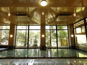 a large room with windows and a pool at Hotel Nanpuso in Hakone +81 photos