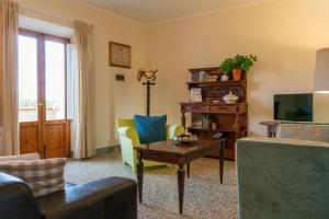 a living room with a couch and a table at Podere Bellavista in Rosignano Marittimo