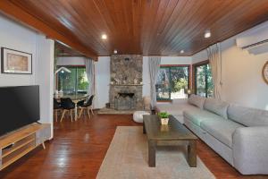 a living room with a couch and a fireplace at THE HOUSE ROSH PINA - 2BRM WITH POOl in Rosh Pinna
