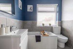 a bathroom with a white sink and a toilet at HIGHBANK HOUSE - Three Bed Stylish House in North Yorkshire in Harrogate +33 photos