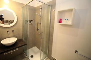 a bathroom with a glass shower and a sink at Villa Lina B&B in San Felice Circeo