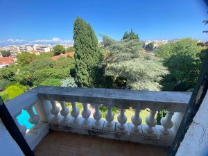 a balcony with a view of trees and bushes at Magnifique propriété - Piscine - Mer in Antibes