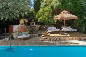 a swimming pool with a hammock and an umbrella at THE HOUSE ROSH PINA - 3BRM WITH POOl in Rosh Pinna