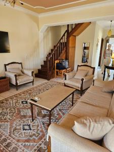 a living room with a couch and a table at Cedar House a Greek treasure in Sami +26 photos