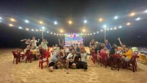 a group of people sitting in chairs in front of a stage at Homestay Hoàng Phúc in Cu Lao Thu