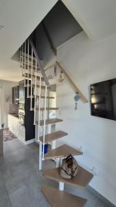 a staircase in a living room with white walls at La dimora di Matteo in Marina di Montenero