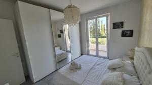 a bedroom with a large mirror and a bed at La dimora di Matteo in Marina di Montenero