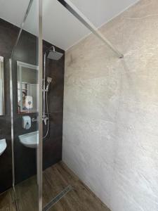 a bathroom with a shower and a sink at Мотель "Козачок" з рестораном у Чинадієві in Mukacheve +13 photos