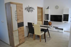 a dining room with a table and chairs at Prenočišča Dany APARTMA 1 in Dravograd
