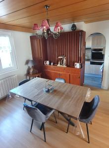 a dining room with a wooden table and chairs at Le Meix du Lac 3 étoiles - 200 m du lac - 50 m navette ski in Gérardmer