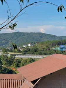 a roof of a building with a view of a mountain at Nhà Dưới Đồi Homestay in Ấp Man Ling
