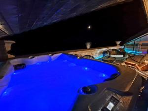 a large blue hot tub in a room at Villa Bellavista in Kavarna