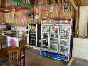 a drink stall in a restaurant with a drink cooler at Hotel Oasis Port Barton in San Vicente