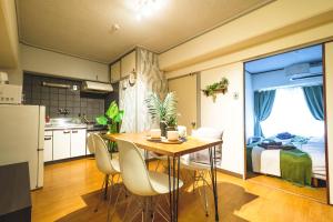 a kitchen and dining room with a table and a bed at Rose Heights -vacation rental- in Osaka +24 photos