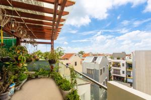 a balcony with plants and a view of a city at Hoi An Legend Connect Villa in Hoi An