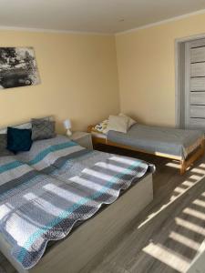a bedroom with two beds and a window at Apartament Koszarawa in Koszarawa +19 photos