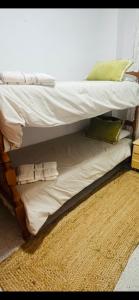 a bunk bed with white sheets and pillows on it at Sun & Salt Lo Pagan in San Pedro del Pinatar
